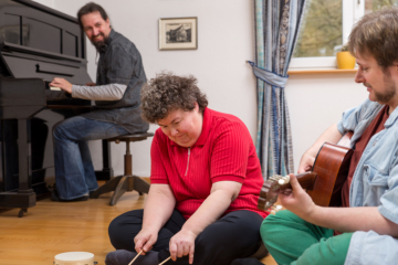 two men and woman playing instruments