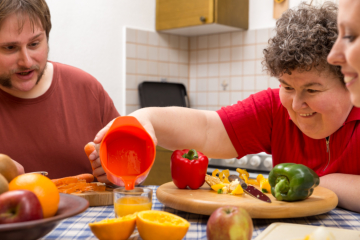 man and woman preparing meal